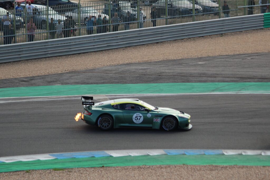 A fire breathing Aston Martin DBR9 race car at the Estoril Classics 2021 event.