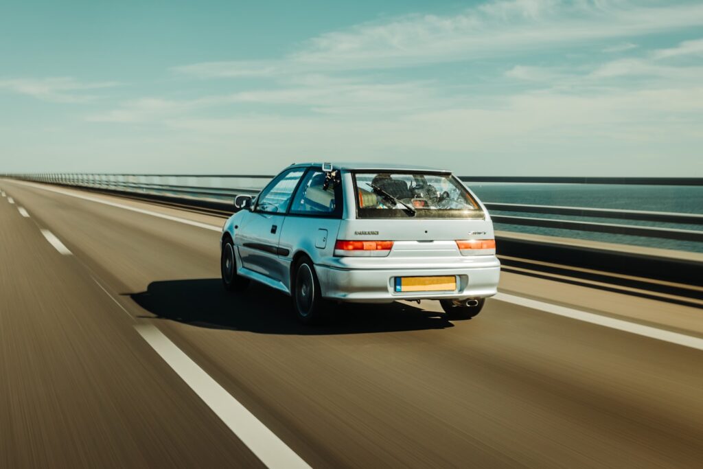 Silver Suzuki Swift Car on The Great Belt Bridge